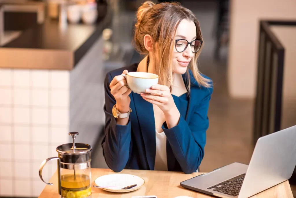 Business woman drinks coffee.