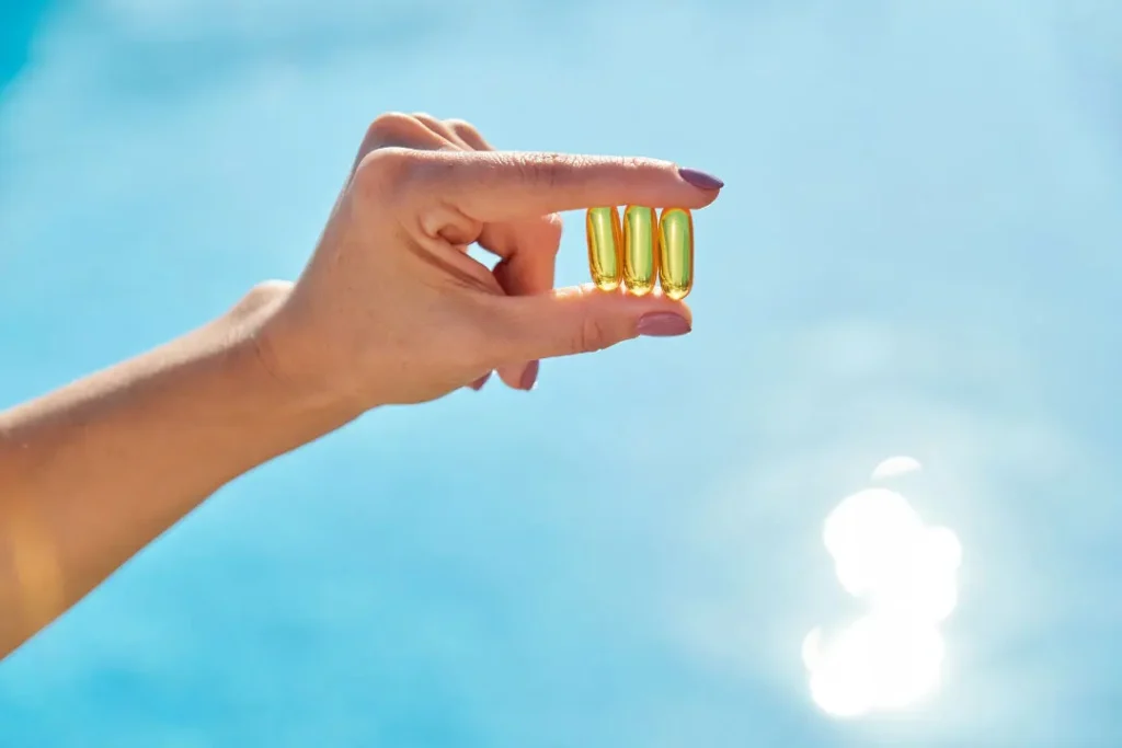 women holding vitamin d capsule