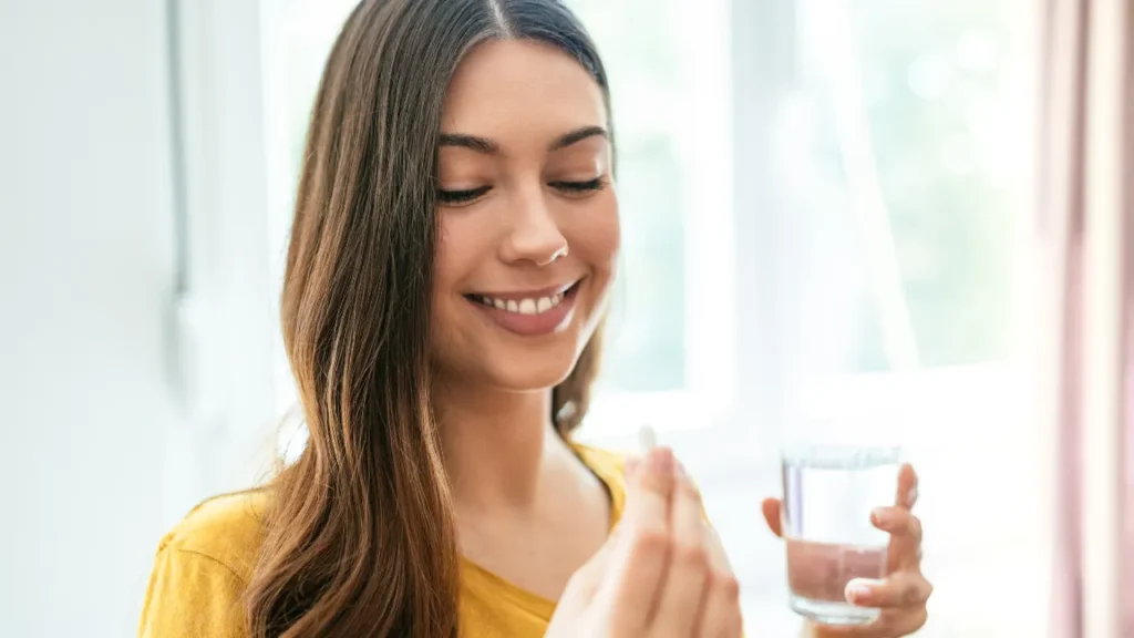 Girl taking nutritional supplement